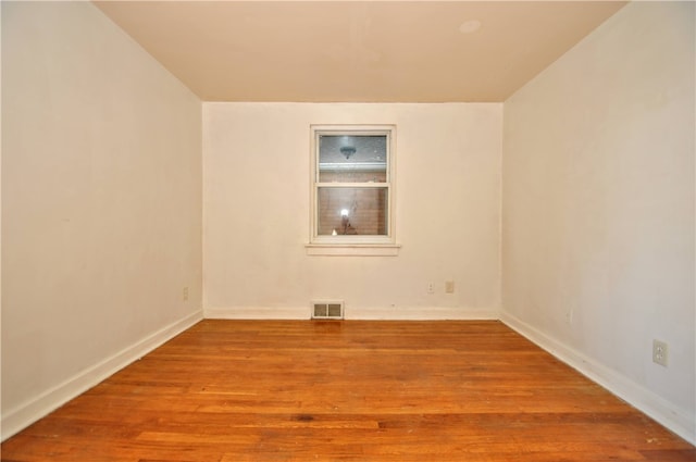 spare room featuring wood-type flooring