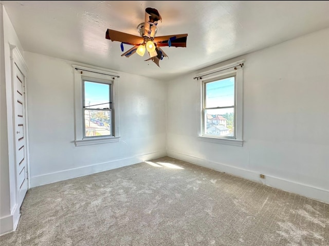 unfurnished room with carpet flooring and ceiling fan