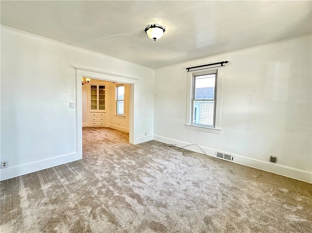 unfurnished room featuring crown molding and carpet floors