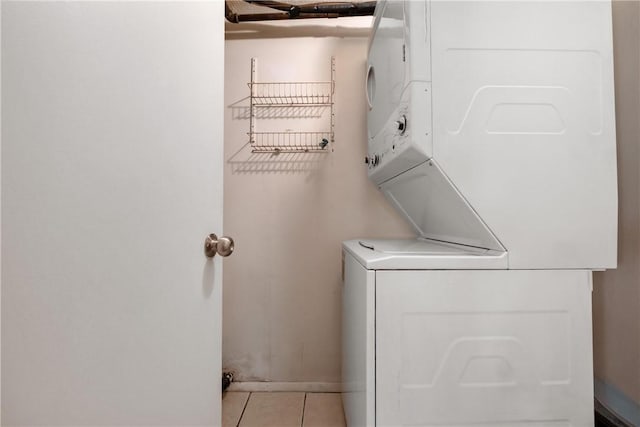 washroom with laundry area, stacked washer / dryer, and tile patterned floors