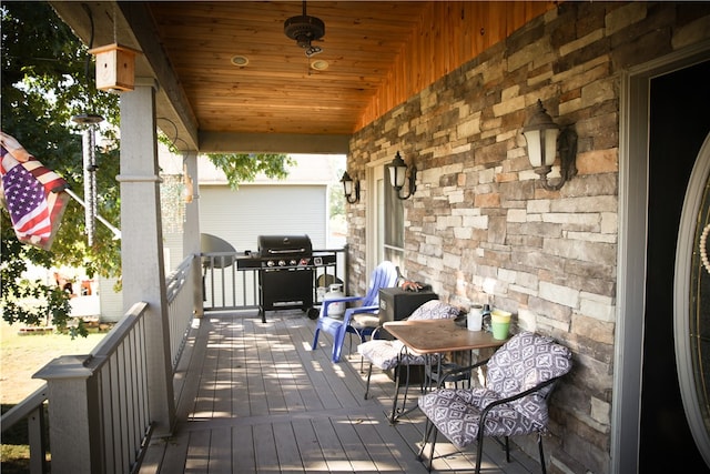 wooden deck featuring a grill