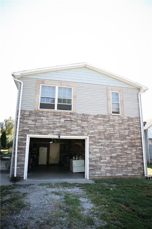 rear view of house with a garage