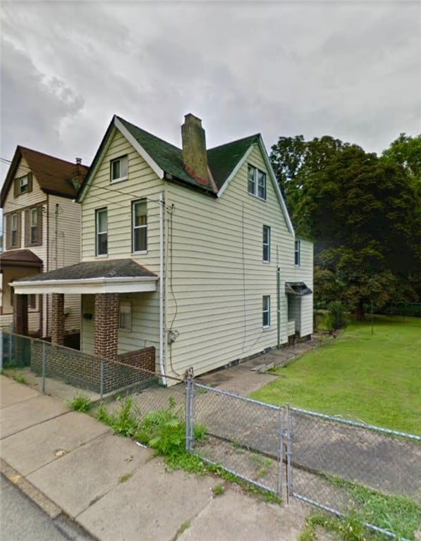 121 Watkins Ave, Wilmerding, PA 15148 - view of side of home featuring a chimney, a gate, and covered porch