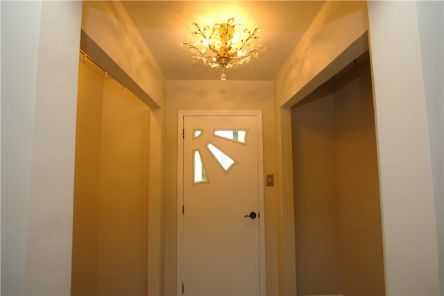 doorway to outside with a chandelier