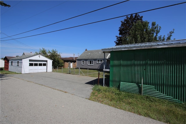 exterior space featuring a garage and an outbuilding