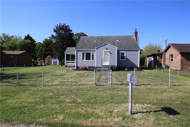 back of house with a storage shed and a lawn