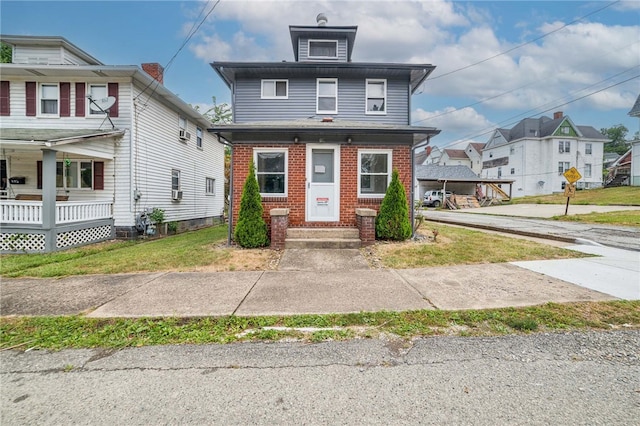 view of front of home with a porch and a front yard