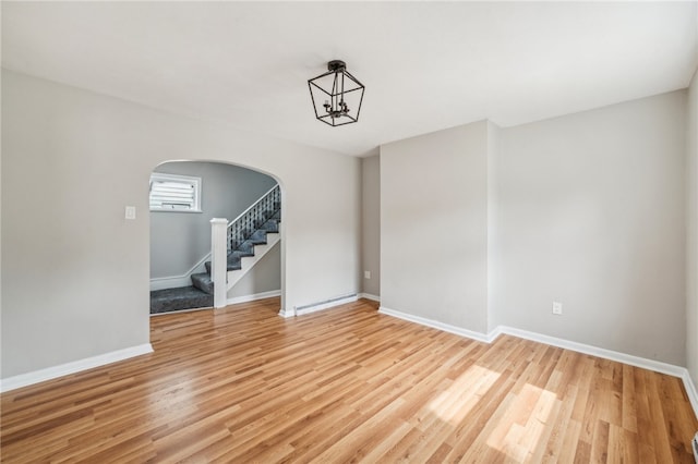 interior space featuring light hardwood / wood-style floors and a notable chandelier