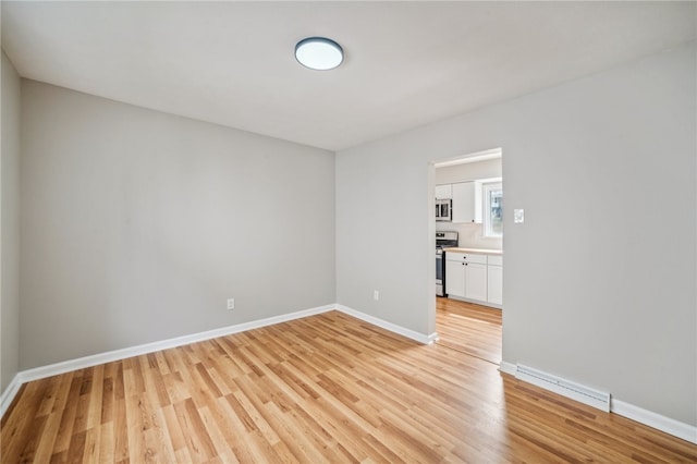 spare room featuring light hardwood / wood-style flooring