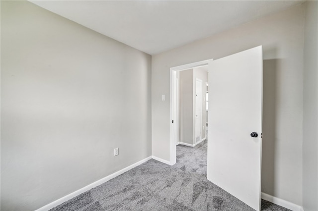 spare room featuring light colored carpet