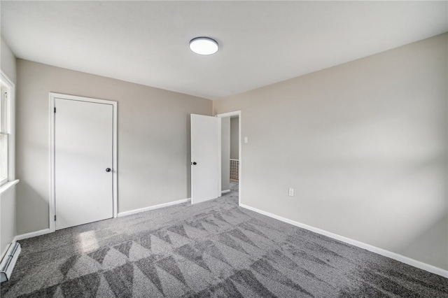 unfurnished bedroom featuring a closet, carpet flooring, and a baseboard radiator