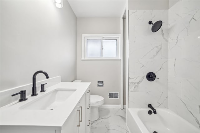 full bathroom featuring tiled shower / bath combo, vanity, and toilet