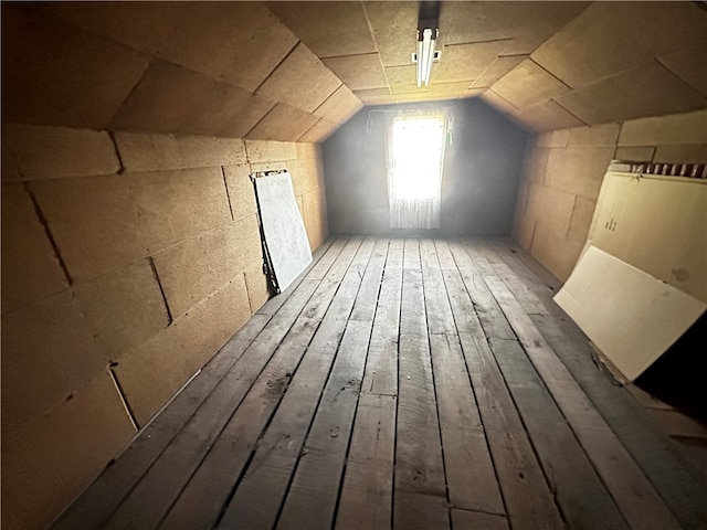 bonus room with lofted ceiling and hardwood / wood-style flooring