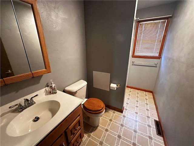 bathroom featuring vanity and toilet