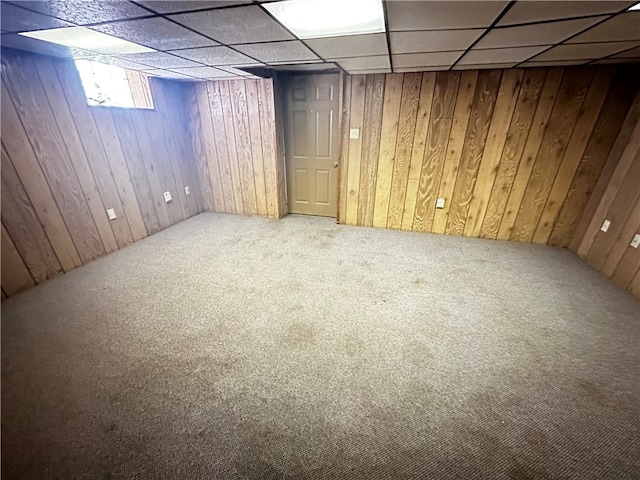 basement featuring carpet flooring and a paneled ceiling