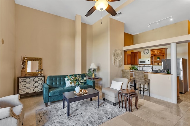 tiled living room featuring ceiling fan