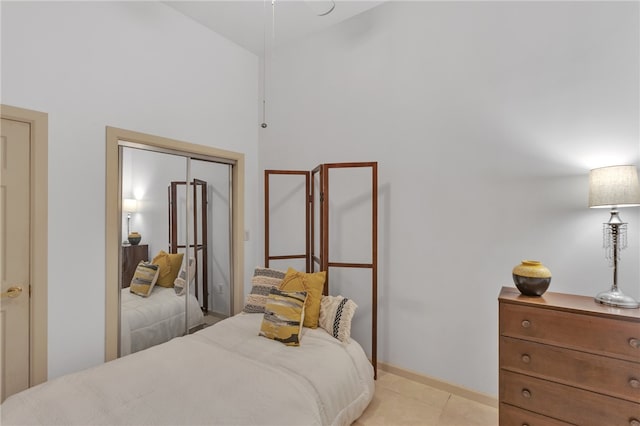 tiled bedroom featuring a closet