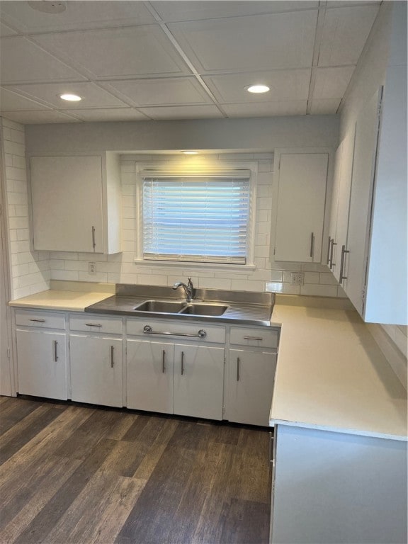 kitchen with white cabinets, dark hardwood / wood-style floors, decorative backsplash, and sink