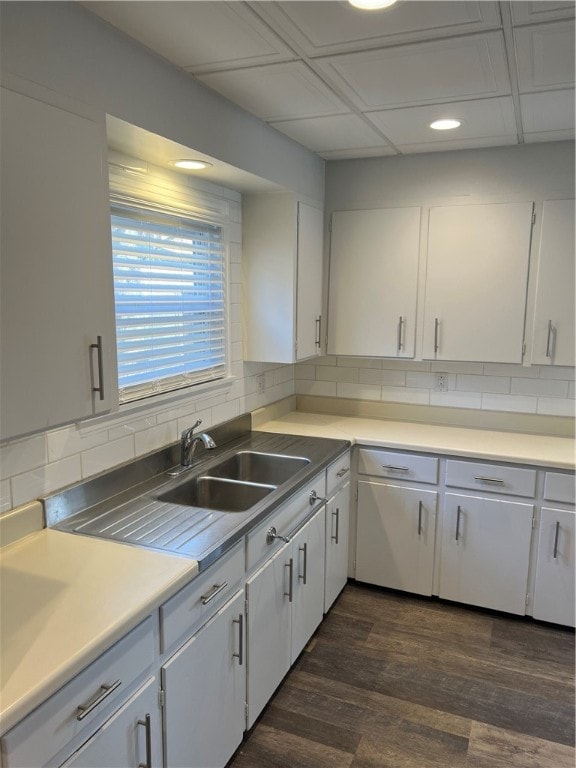 kitchen featuring white cabinets, backsplash, dark hardwood / wood-style flooring, and sink