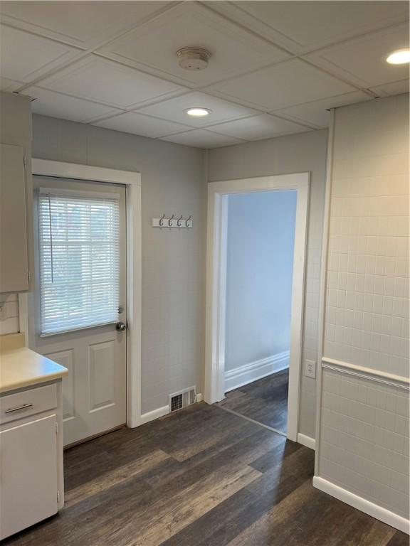 corridor featuring dark wood finished floors, recessed lighting, baseboards, and visible vents