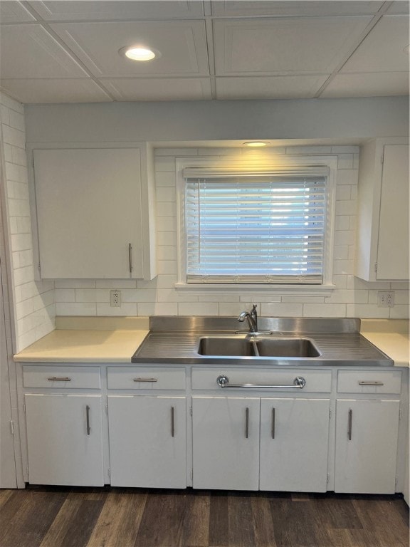 kitchen with dark hardwood / wood-style flooring, white cabinetry, and sink