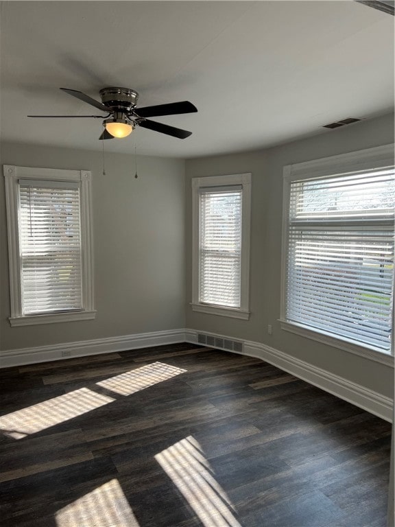 empty room featuring ceiling fan and dark hardwood / wood-style flooring