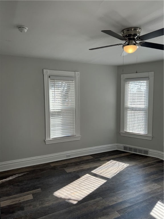 empty room featuring dark hardwood / wood-style flooring and ceiling fan