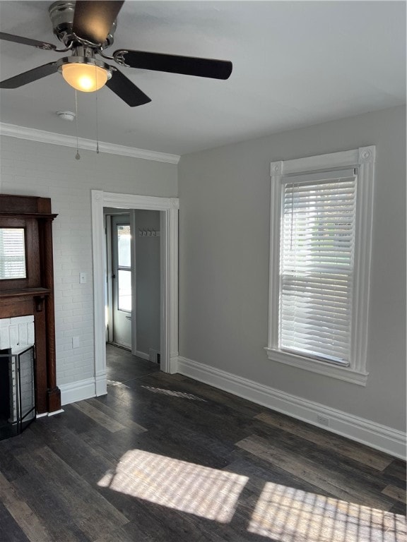 unfurnished living room with crown molding, ceiling fan, and dark hardwood / wood-style floors