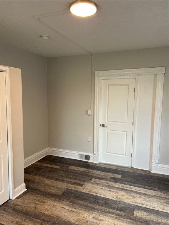 empty room featuring dark hardwood / wood-style flooring