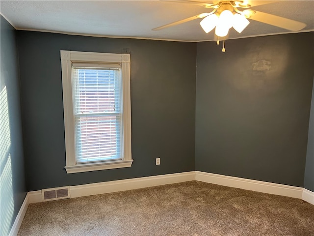 empty room featuring carpet flooring and ceiling fan