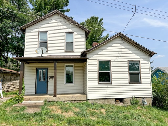 view of property featuring covered porch