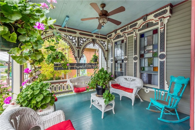 balcony featuring a porch and ceiling fan