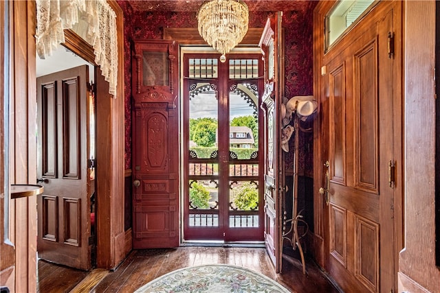 entrance foyer featuring an inviting chandelier and hardwood / wood-style flooring