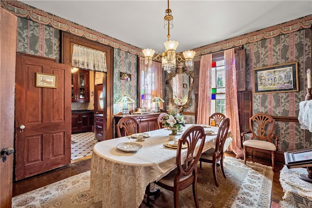 dining room with wood-type flooring and a chandelier