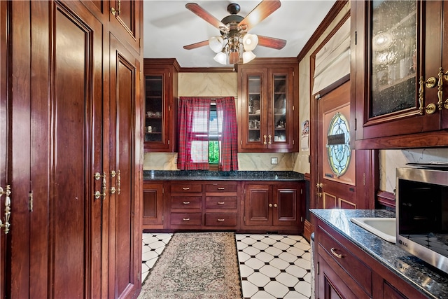 interior space with ceiling fan and crown molding