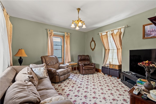 living room with plenty of natural light, an inviting chandelier, and light carpet