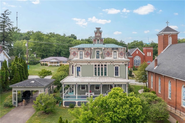 back of property with a porch and a carport