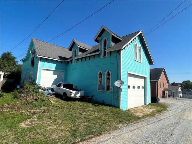 view of side of home with a garage and a yard