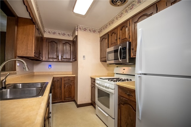 kitchen with white appliances and sink