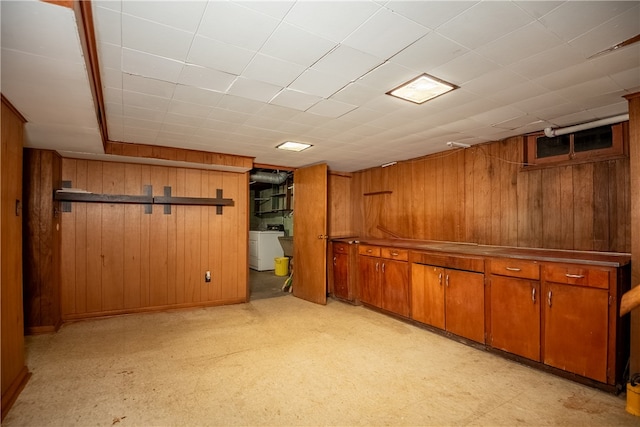 basement with washer / dryer and wood walls