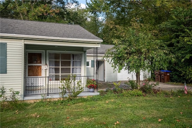 314 Lunn Blvd, Farrell, PA 16121 - view of front facade with covered porch, a garage, a front yard, and a shingled roof