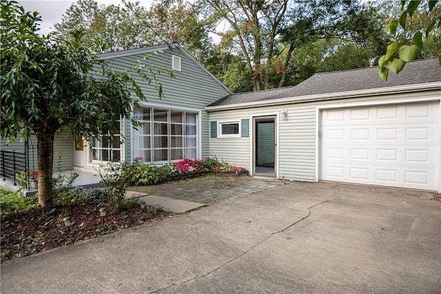 rear view of house with a garage