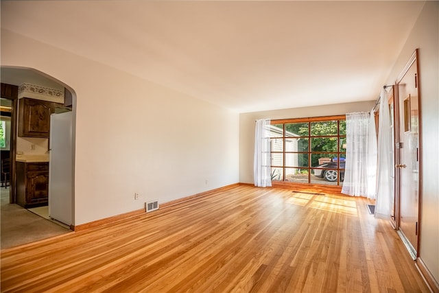 spare room with light hardwood / wood-style floors