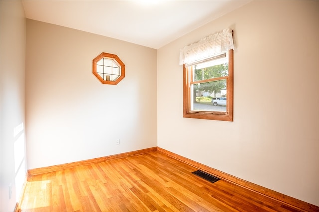 unfurnished room with wood-type flooring