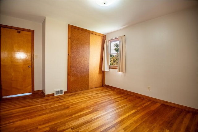 314 Lunn Blvd, Farrell, PA 16121 - unfurnished bedroom featuring wood finished floors, baseboards, a closet, and visible vents