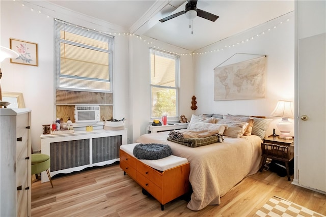 bedroom featuring light hardwood / wood-style floors, radiator heating unit, and ceiling fan