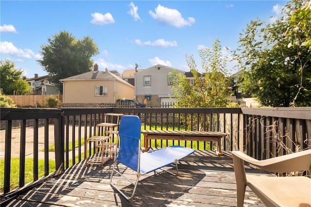 wooden deck featuring fence and a residential view