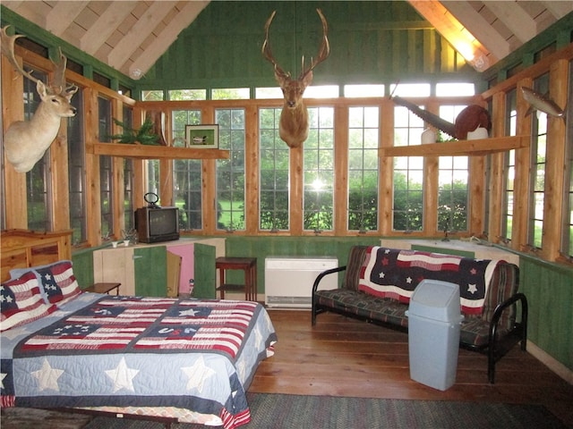 sunroom featuring radiator and vaulted ceiling with beams