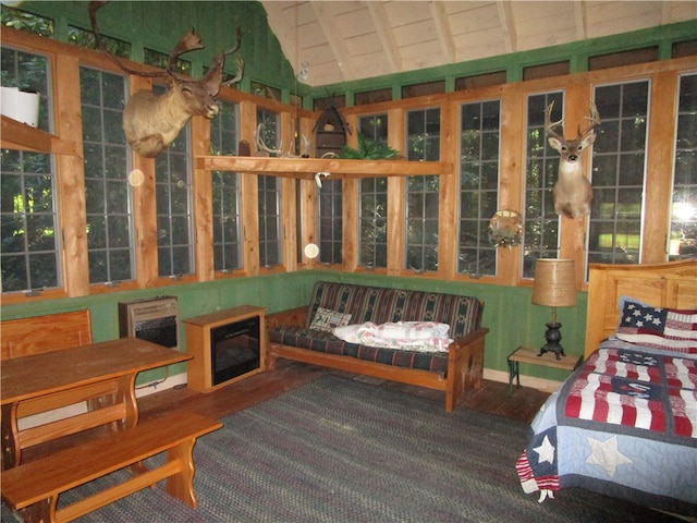 sunroom / solarium featuring lofted ceiling with beams and heating unit