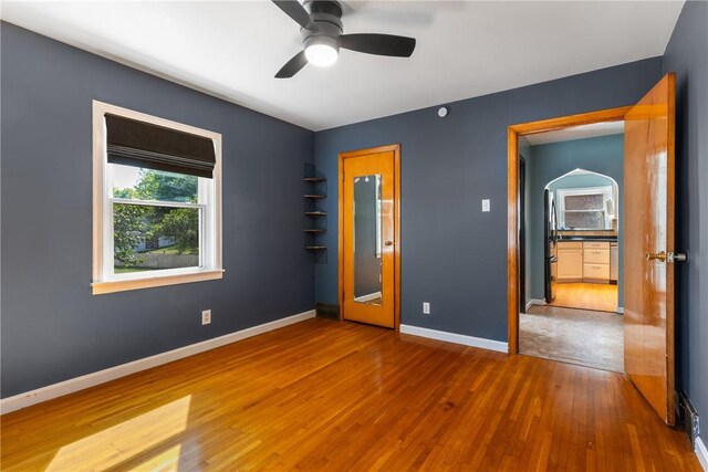 17 Long St, Hanover Twp Wsh, PA 15021 - unfurnished bedroom featuring hardwood / wood-style floors, baseboards, arched walkways, freestanding refrigerator, and a ceiling fan
